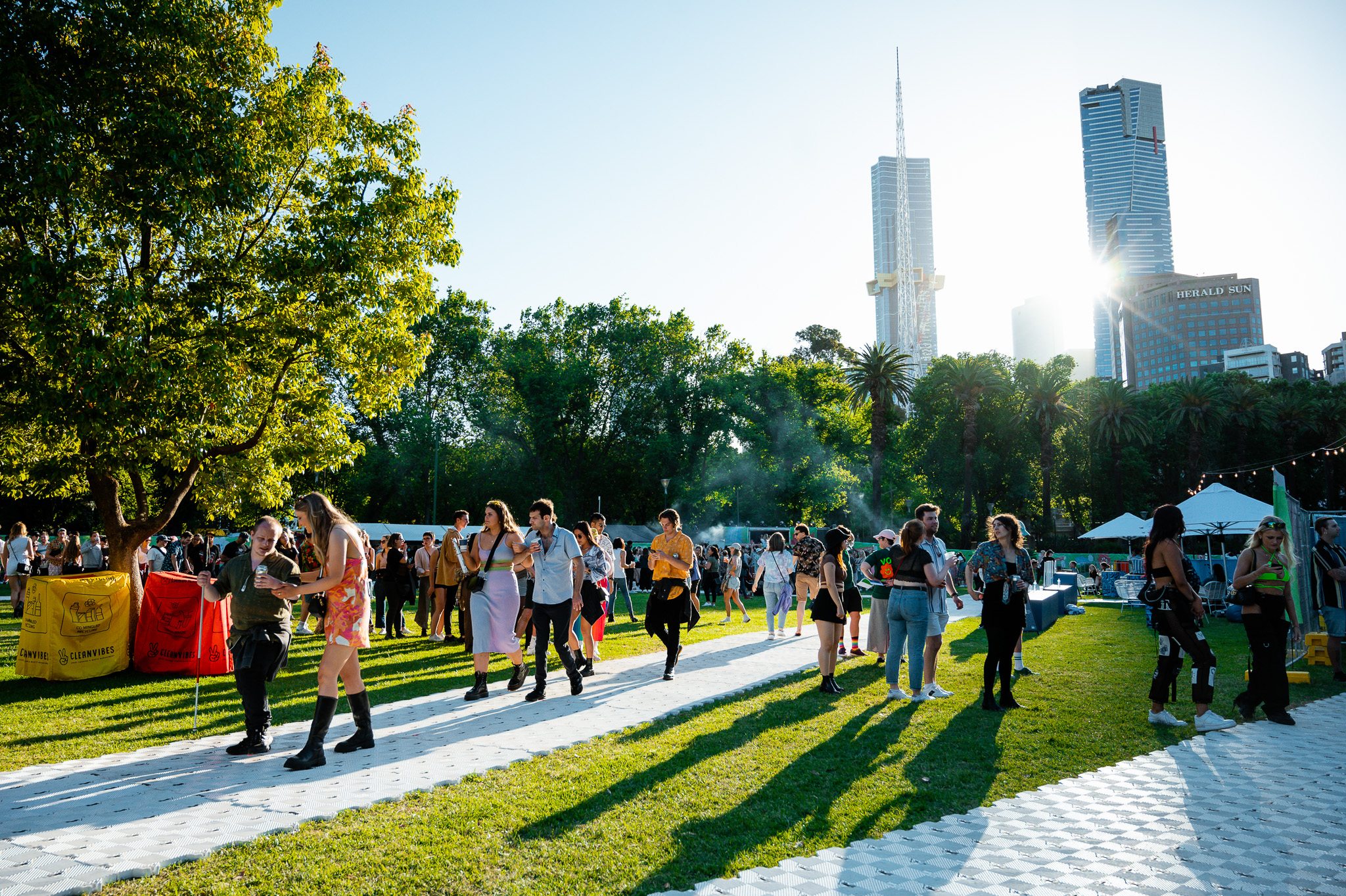 People walking around Ability Fest with the Melbourne CBD in the background. 