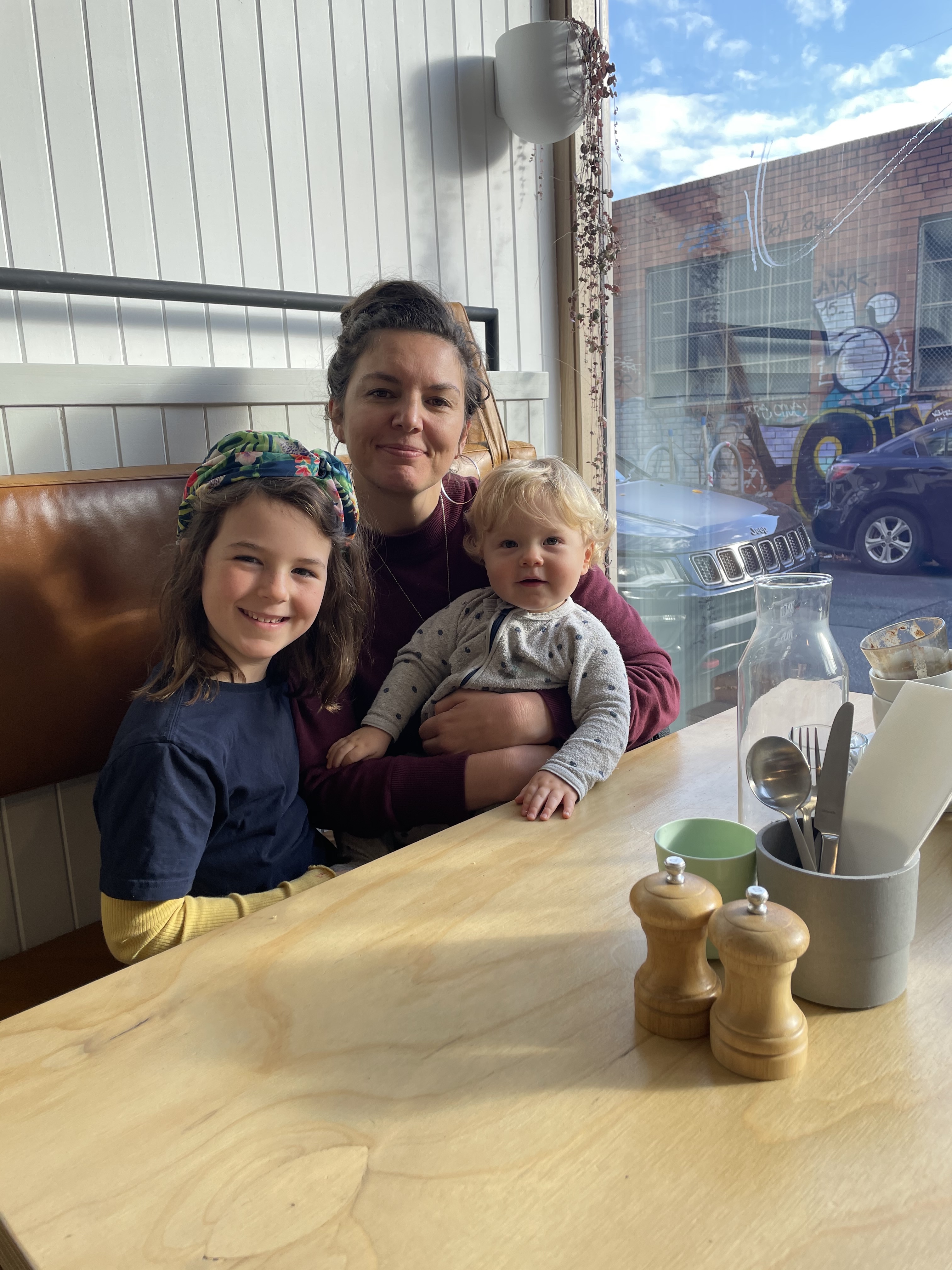 Eliza Hull sitting at a cafe with her two children
