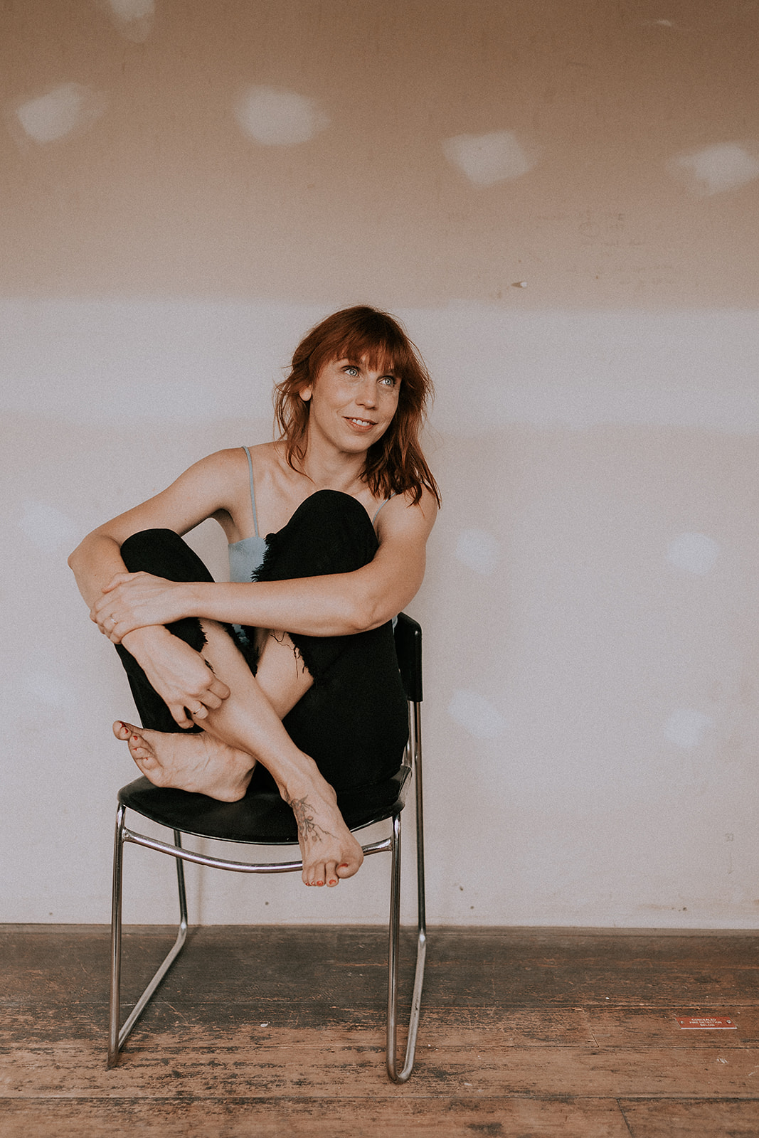 Emma Bosworth sitting on a chair with her legs crossed