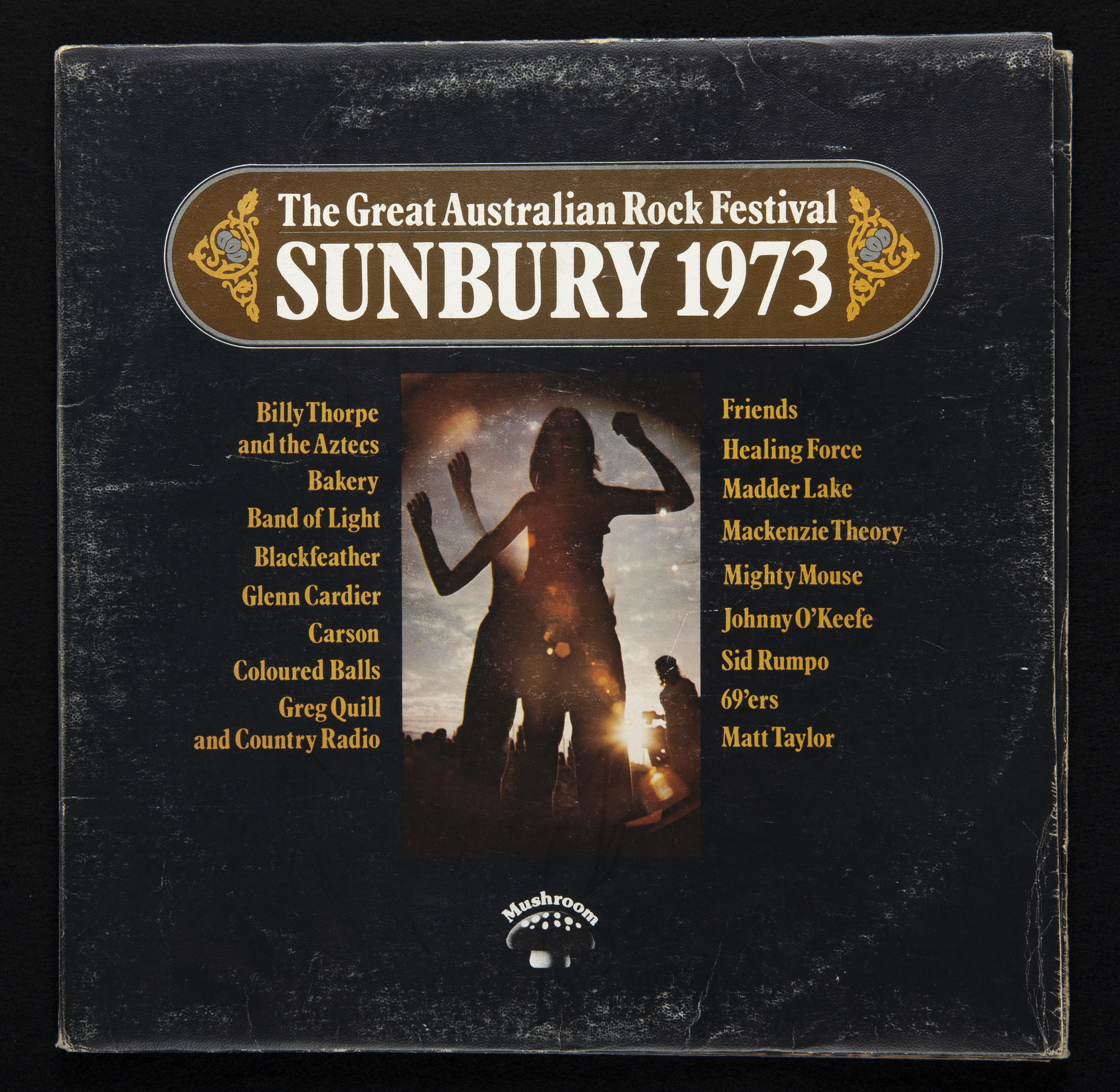 The Great Australian Rock Festival Triple Album cover. The album is black with gold text and has the shadow of people dancing.