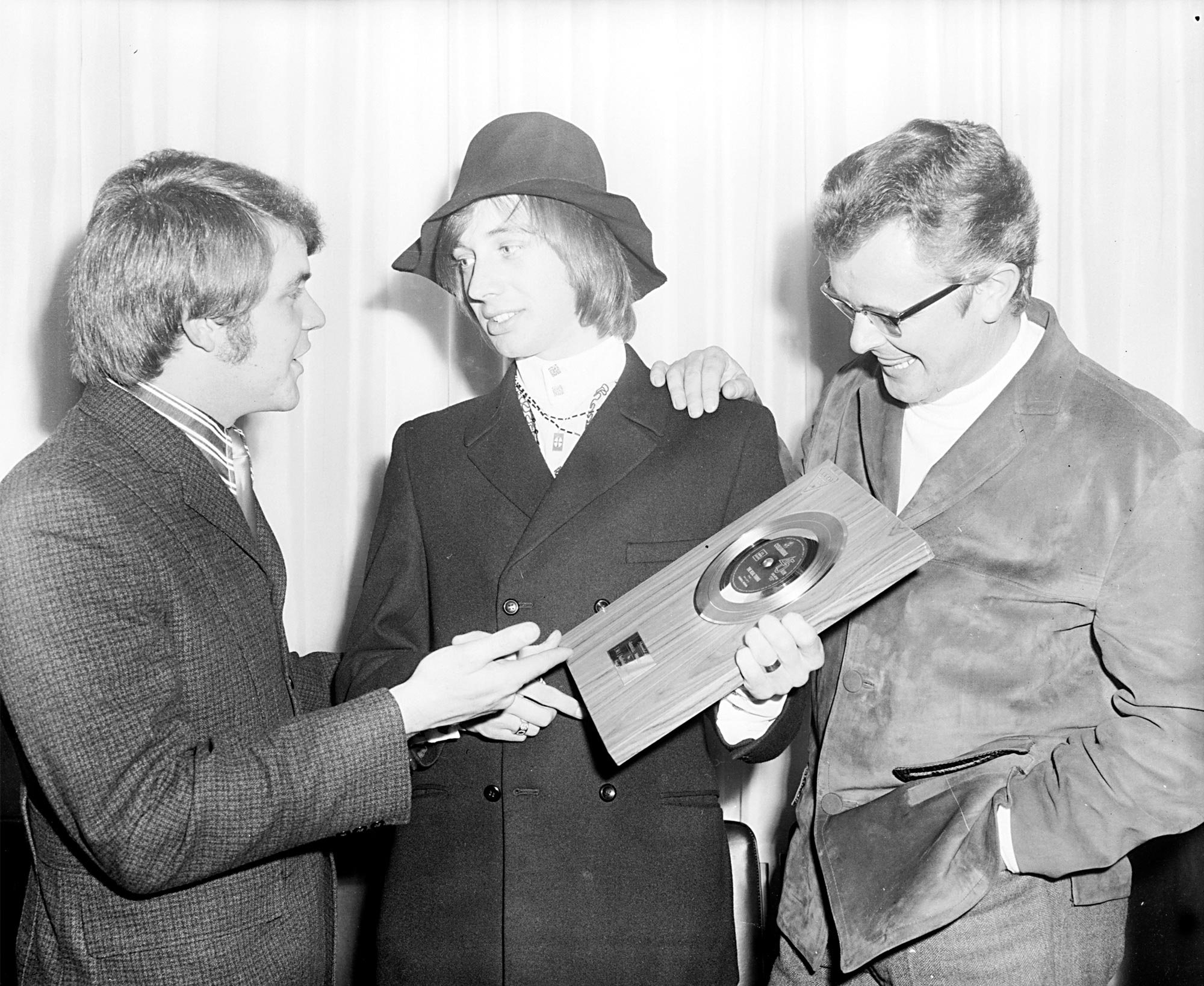 Ross D. Wiley and Dick Williams presenting Russell Morris with a gold record for ‘The Real Thing,’ 1969