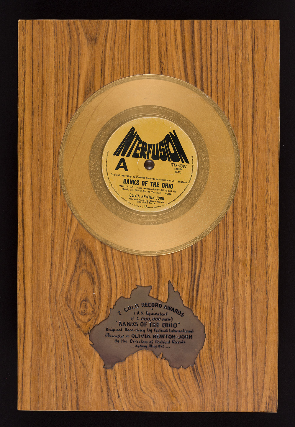 Gold record award for ‘Banks of the Ohio’ presented to Newton-John by the directors of Festival Records, 1972