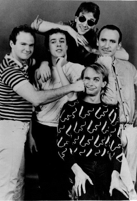 A black and white image of the band, Men at Work. 